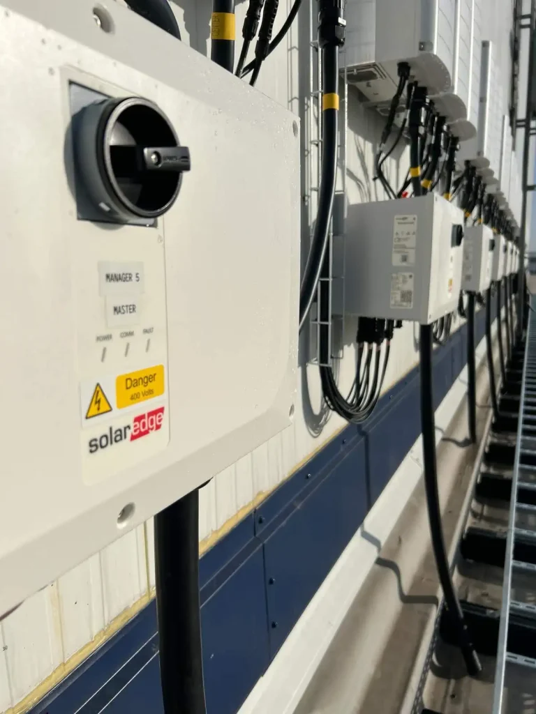 Wall-mounted solar power system with labeled electrical boxes