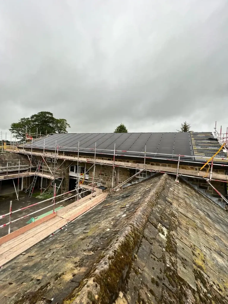 Building under construction with scaffolding and rooftop solar panels
