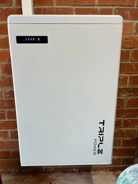 Energy storage unit mounted on brick wall